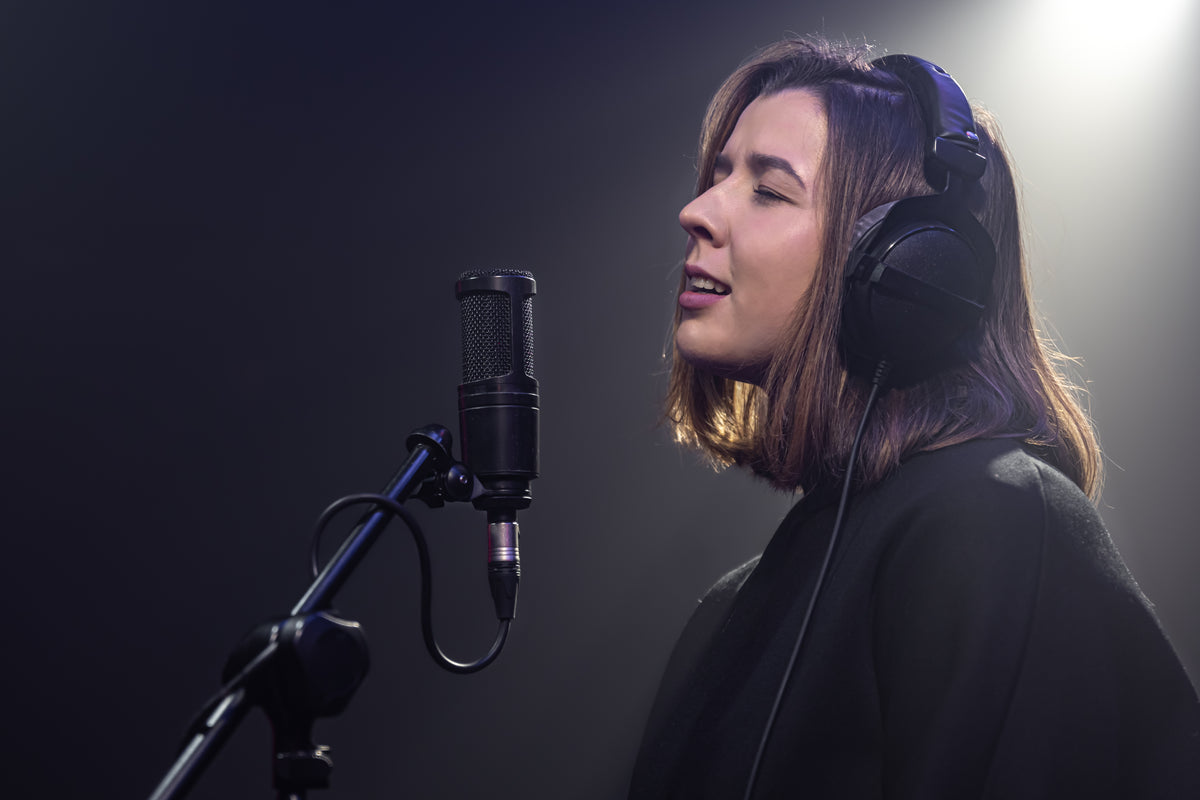 Singer in studio with headphones